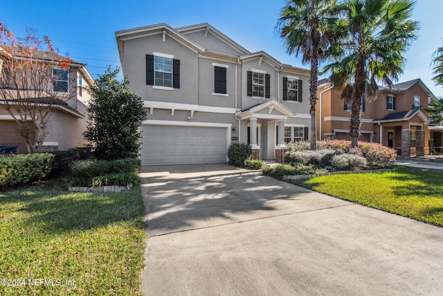 view of front of house featuring a front lawn and a garage