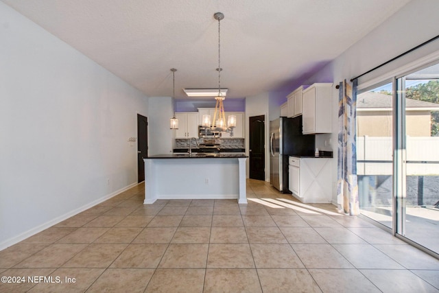 kitchen with pendant lighting, a notable chandelier, white cabinetry, and light tile patterned floors