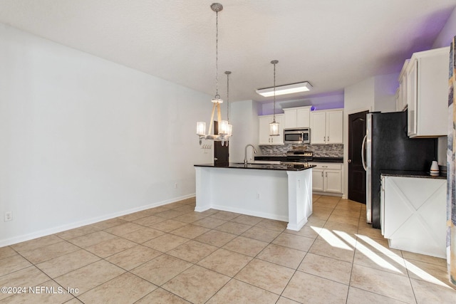 kitchen featuring backsplash, white cabinets, a breakfast bar area, light tile patterned floors, and stainless steel appliances