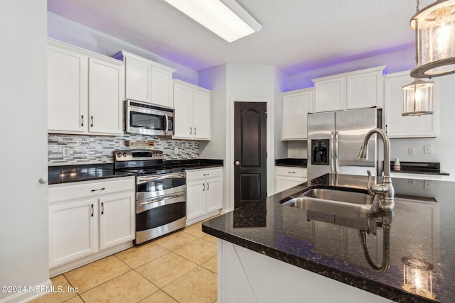 kitchen with white cabinetry, pendant lighting, and appliances with stainless steel finishes