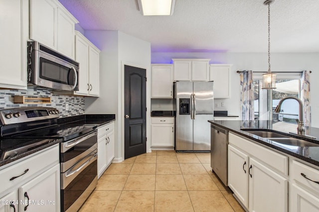 kitchen featuring white cabinets, appliances with stainless steel finishes, a textured ceiling, and sink