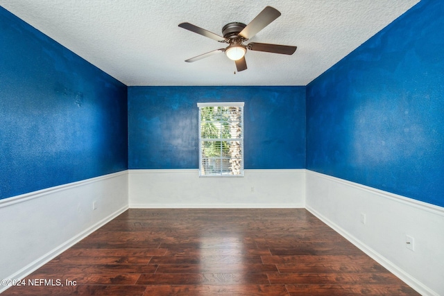 unfurnished room featuring a textured ceiling, ceiling fan, and dark wood-type flooring