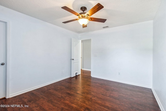 unfurnished room featuring ceiling fan, dark hardwood / wood-style flooring, and a textured ceiling