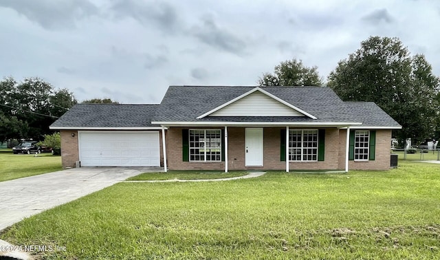 view of front of property featuring a front yard, a garage, and central AC unit