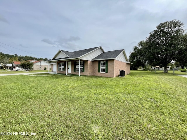 single story home featuring cooling unit and a front lawn