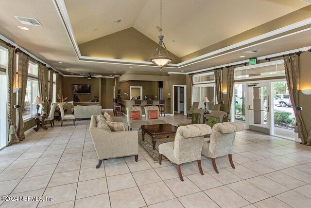 living room featuring vaulted ceiling, a raised ceiling, light tile patterned floors, ceiling fan, and french doors