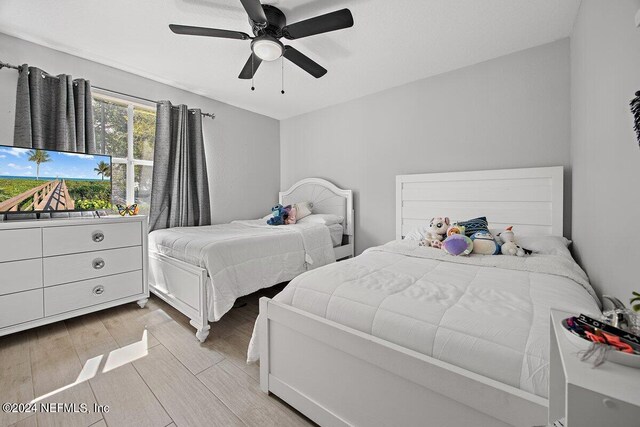 bedroom featuring ceiling fan and light hardwood / wood-style flooring