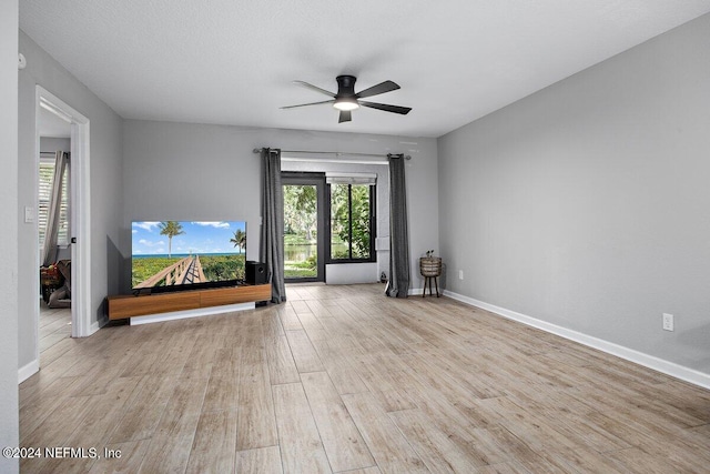 unfurnished living room featuring ceiling fan and light hardwood / wood-style flooring