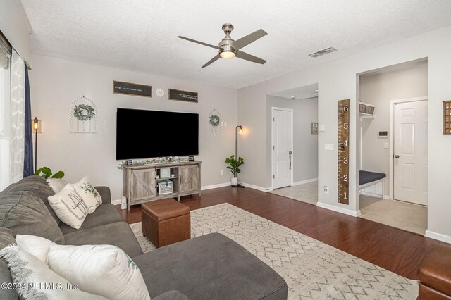 635 Briar View Dr, Orange Park, FL 32065 - living room with a textured ceiling, visible vents, baseboards, wood finished floors, and a ceiling fan