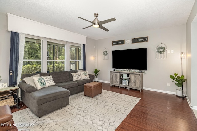 living room with ceiling fan, dark hardwood / wood-style floors, and a textured ceiling