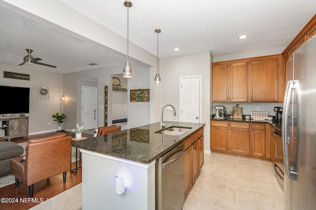 635 Briar View Dr, Orange Park, FL 32065 - kitchen featuring brown cabinets, stainless steel appliances, dark stone countertops, a sink, and open floor plan