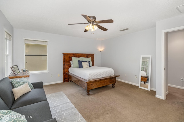 bedroom featuring light carpet and ceiling fan