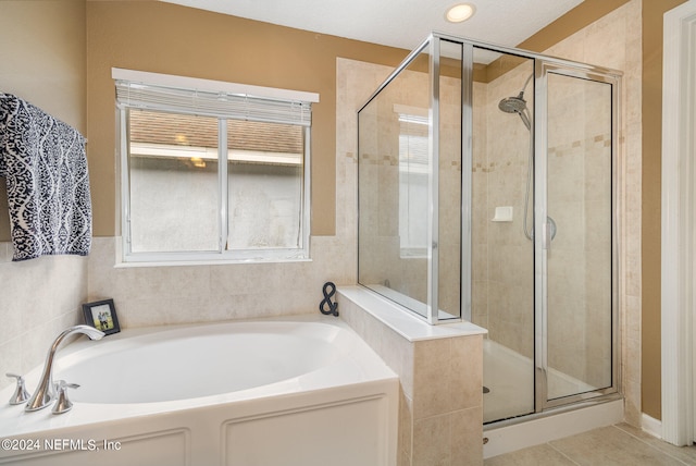 bathroom featuring tile patterned flooring and independent shower and bath