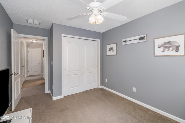 635 Briar View Dr, Orange Park, FL 32065 - unfurnished bedroom with baseboards, a textured ceiling, a closet, and light carpet