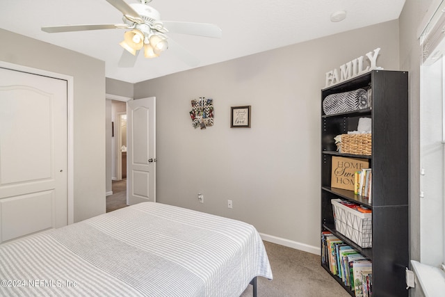 carpeted bedroom featuring ceiling fan and a closet