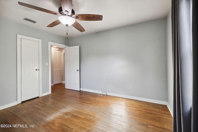 unfurnished bedroom featuring ceiling fan and hardwood / wood-style flooring