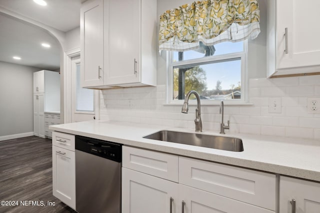 kitchen with white cabinetry, backsplash, dishwasher, dark hardwood / wood-style floors, and sink