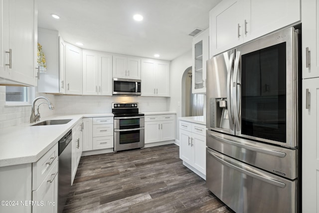 kitchen featuring white cabinets, appliances with stainless steel finishes, and dark wood-type flooring