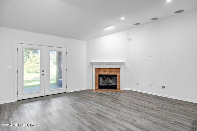 unfurnished living room with french doors, hardwood / wood-style flooring, and a fireplace