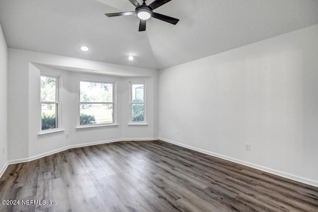 unfurnished room featuring ceiling fan, dark wood-type flooring, and vaulted ceiling