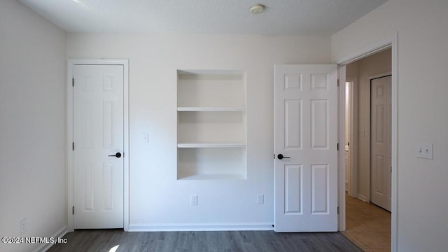 unfurnished bedroom featuring hardwood / wood-style flooring