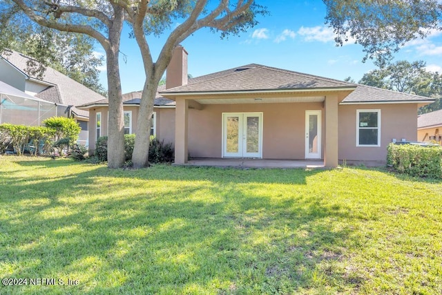 rear view of house featuring a yard and a patio area