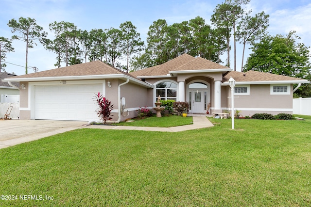 view of front of property with a garage and a front yard