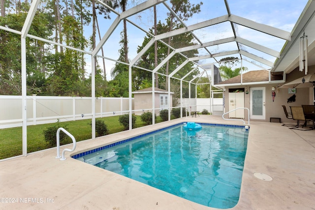 view of pool featuring a shed, a lanai, and a patio area