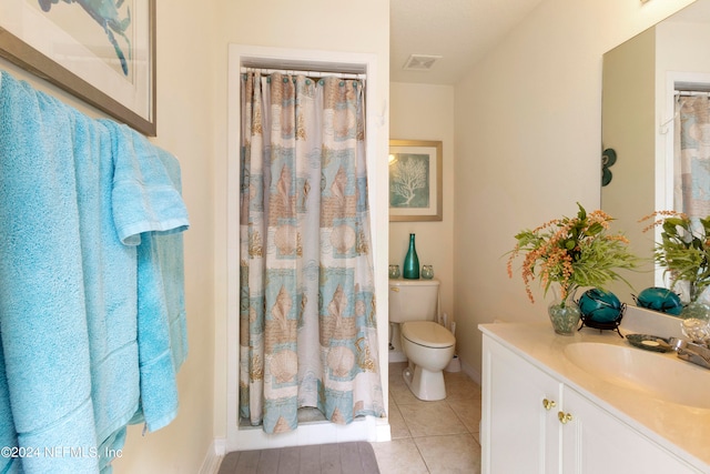 bathroom featuring vanity, toilet, and tile patterned floors