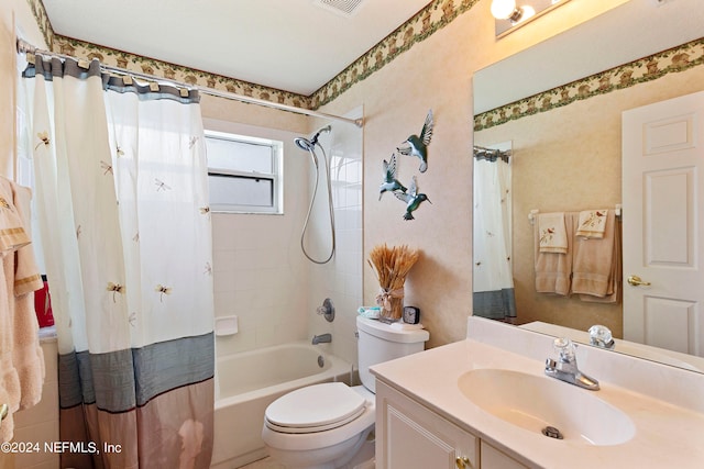 full bathroom featuring vanity, shower / bath combo with shower curtain, and toilet