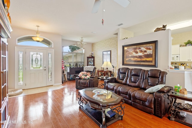 living room featuring light hardwood / wood-style floors and ceiling fan