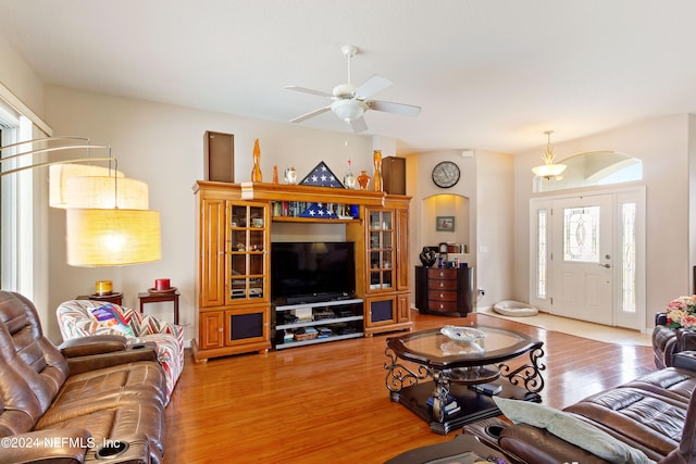 living room featuring wood-type flooring and ceiling fan