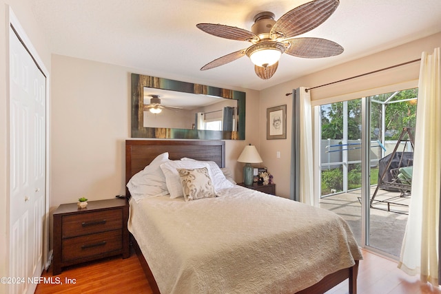 bedroom with ceiling fan, a closet, hardwood / wood-style floors, and access to exterior