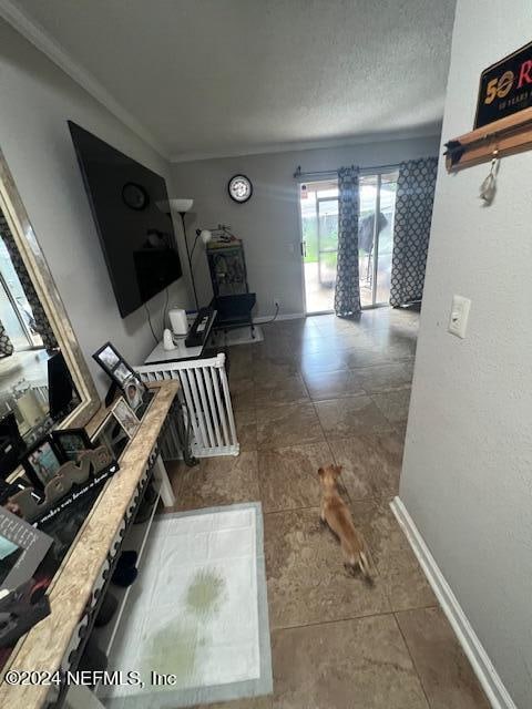 corridor featuring ornamental molding and tile patterned floors