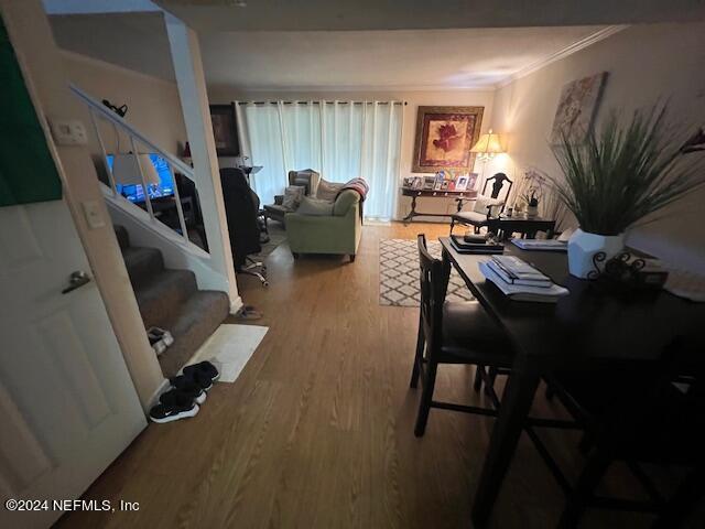 dining area with ornamental molding and hardwood / wood-style floors