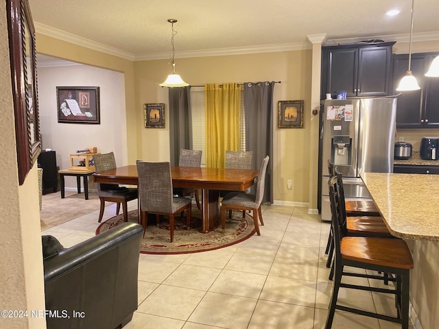 dining room with light tile patterned flooring and ornamental molding