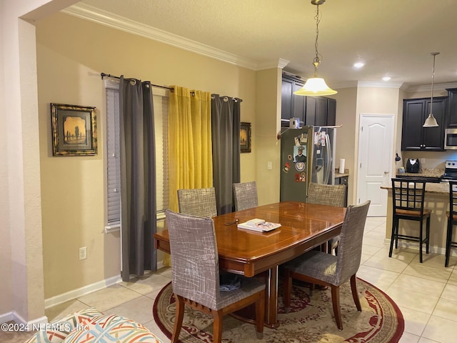 dining area featuring ornamental molding and light tile patterned floors