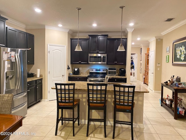 kitchen with a center island with sink, decorative light fixtures, ornamental molding, and stainless steel appliances