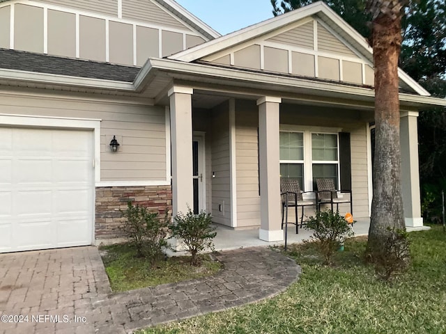 view of exterior entry with covered porch