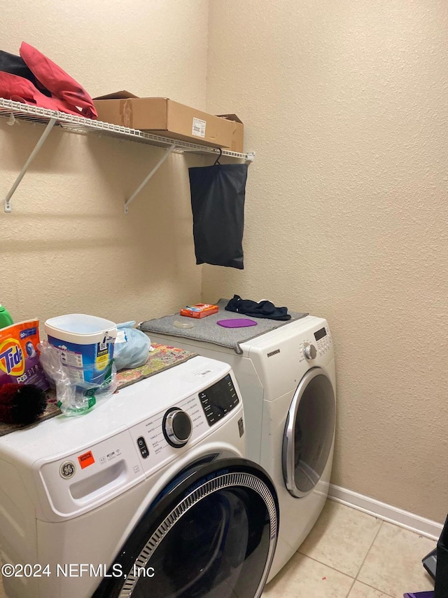 clothes washing area with independent washer and dryer and light tile patterned floors