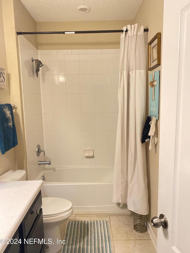 full bathroom featuring vanity, tile patterned flooring, toilet, shower / bathtub combination with curtain, and a textured ceiling