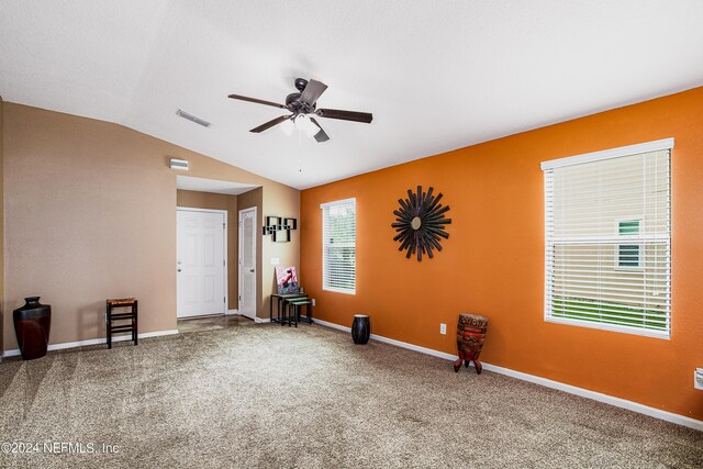 spare room featuring ceiling fan, carpet floors, and lofted ceiling