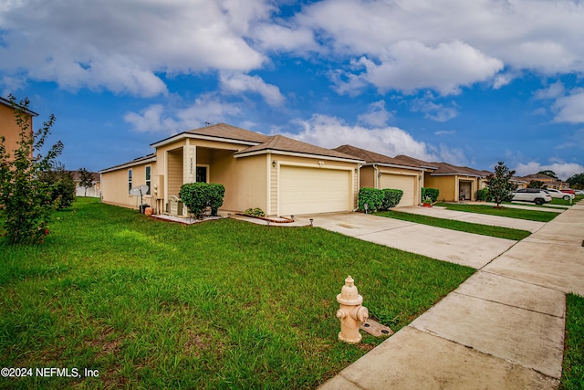 view of front of property with a front lawn and a garage