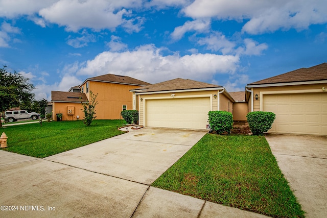 view of front of property with a front yard and a garage