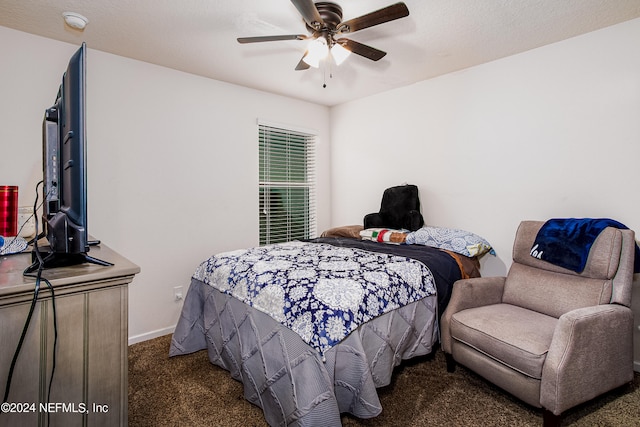 carpeted bedroom featuring a textured ceiling and ceiling fan