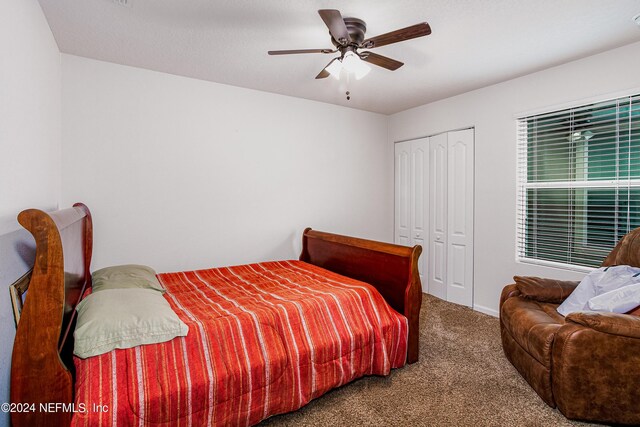 carpeted bedroom with a closet and ceiling fan