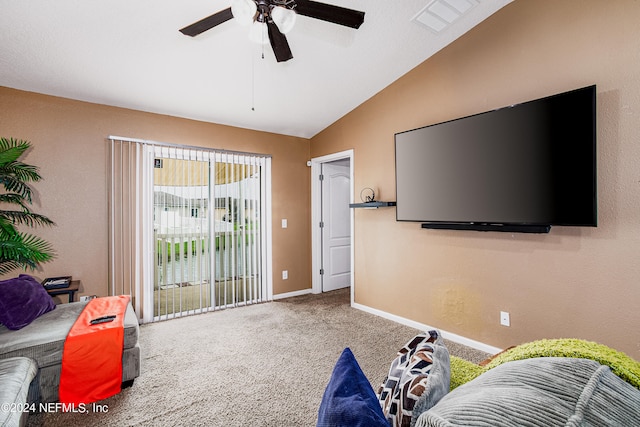 living room featuring ceiling fan, vaulted ceiling, and carpet flooring