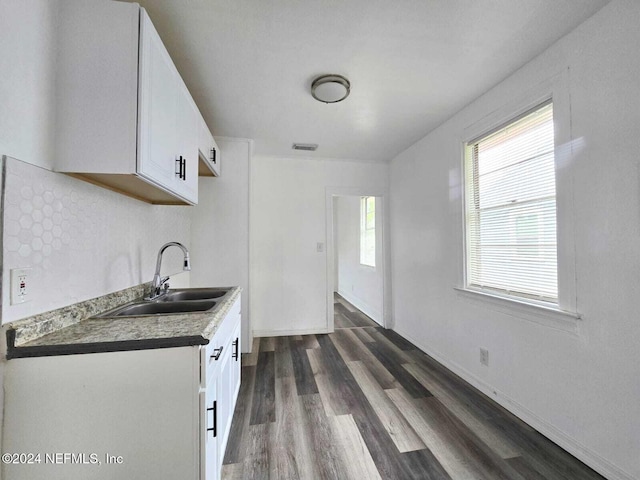 kitchen with white cabinetry, tasteful backsplash, sink, and dark hardwood / wood-style floors