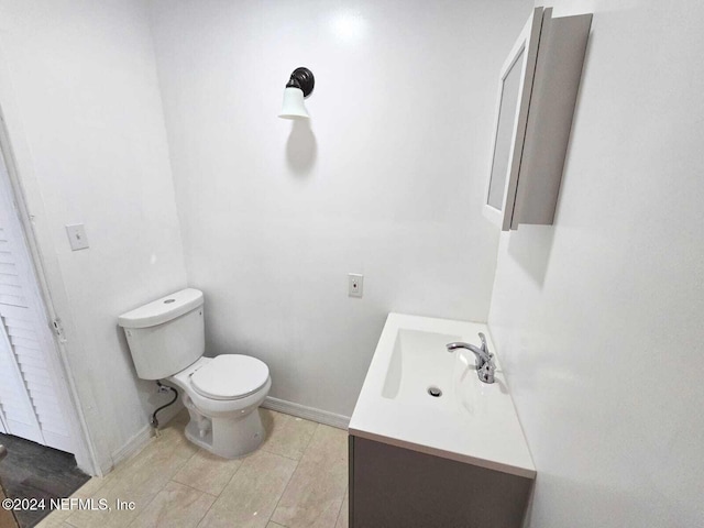 bathroom featuring vanity, toilet, and tile patterned floors