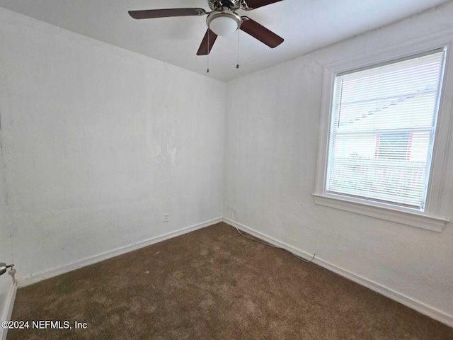 carpeted empty room featuring ceiling fan